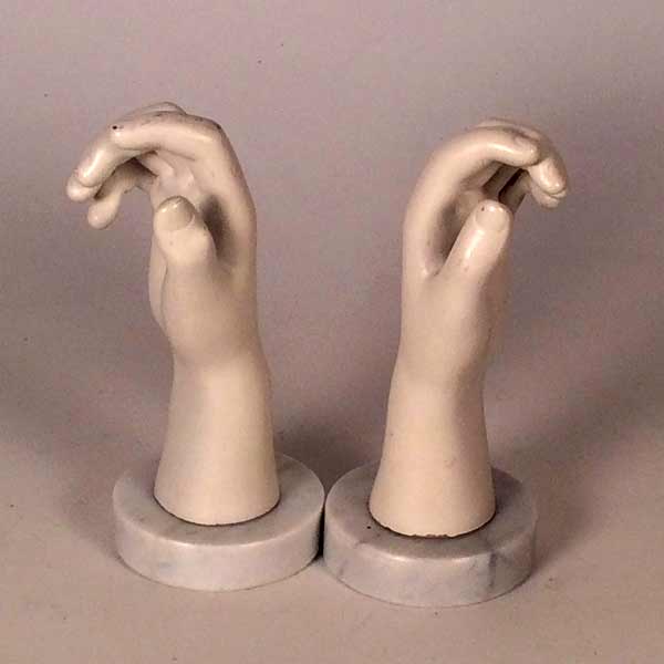 A pair of marble mounted mannequin hands.